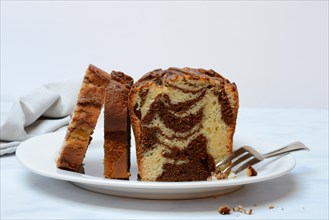 Marble cake with cake fork on plate