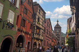 Colourful half-timbered houses with old tower of the historic old town of Riquewihr