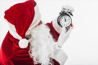 Santa claus looking at clock in hands