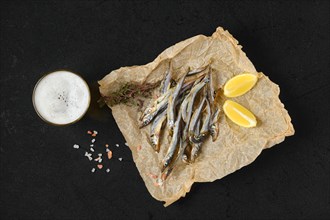 Overhead view of smoked smelt in wrapping paper
