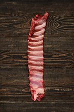 Overhead view of raw deer ribs over wooden background