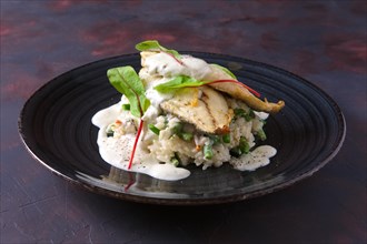 Fried fillet of white fish with rice and green beans decorated with chard