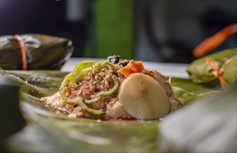 Close-up of the raw ingredients of the Nicaraguan nacatamal on banana leaves. Raw ingredients for the preparation of the traditional Nacatamal