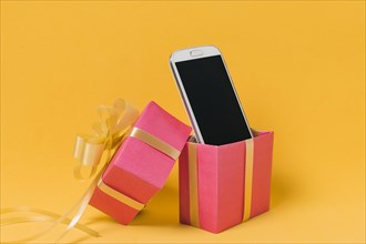 Mobile phone with blank screen pink gift box