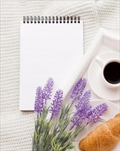 Notebook beside tray with breakfast