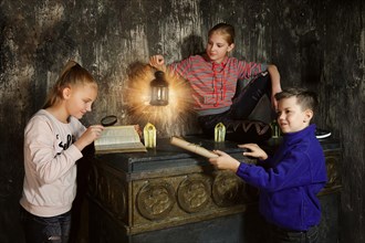 Three children in quest game solving a puzzle
