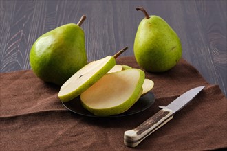 Pears and knife on wooden table
