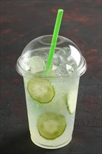 Fresh cold cucumber ice drink in take away plastic glass with straw