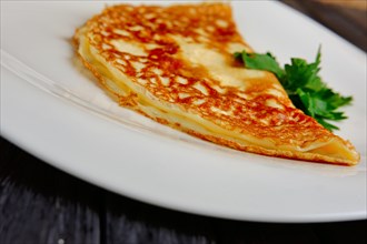 Selected focus photo of plate with thin omelet
