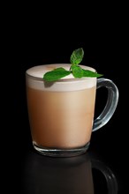Transparent cup of mint Cappuccino isolated on black