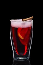 Double-walled glass with hot mulled wine isolated on black