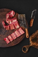 Raw fresh beef short rib stripes on wooden chopping slab