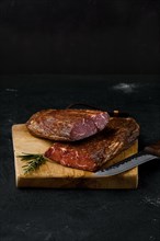 Smoked beef striploin meat on cutting board