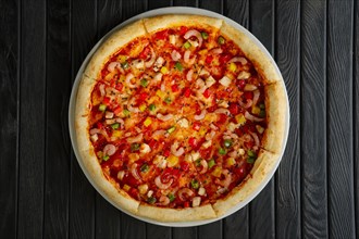 Top view of pizza with shrimps and chicken fillet