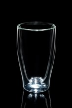 Empty double walled coffee glass isolated on black