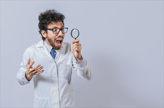 Surprised scientist observing with a magnifying glass to the side. Scientist holding a magnifying glass looking to the side