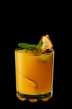 Hot pear and orange winter drink with mint isolated on black