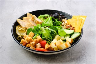 Bowl with salad mix and various snacks as a starter