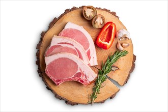 Raw fresh pork fillet steak on the bone on wooden cutting board isolated on white