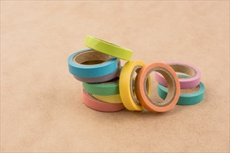 Colorful insulating adhesive tapes on yellow background