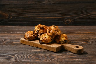 Cookies with raisins on wooden cutting board