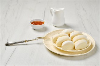 Semifinished frozen lazy dumplings made of curd on a plate