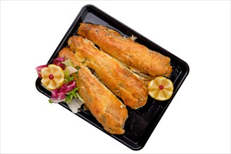 Baked fish in batter on tray isolated on white