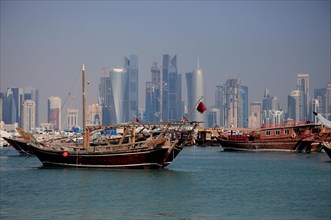 Fishing boats in front of the skyline of Doha