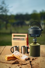 Making coffee or tea on portable gas stove on the nature. Travel