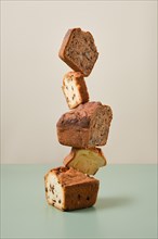 Stacked pieces of biscuit cupcakes. Balancing cakes
