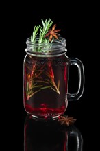 Hot cherry tea with cinnamon and rosemary in mason jar
