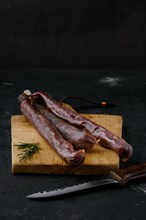 Dry cured beef sausage on cutting board