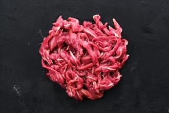 Top view of raw duck breast on black concrete background
