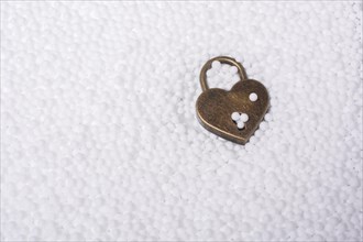 Metal padlock in heart shape as symbol of love