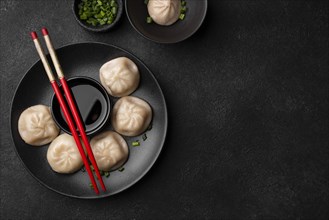 Flat lay asian dumplings with chopsticks copy space