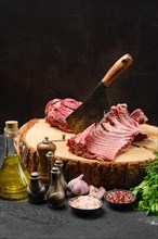 Raw lamb ribs and shoulder on butcher stump