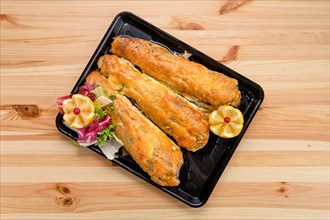 Baked fish in batter on tray