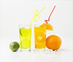 Front view fruit juice glasses with straws