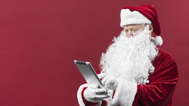 Santa claus hat using tablet