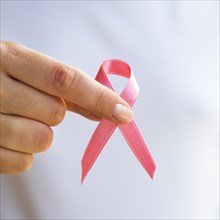 Close up person holding awareness ribbon