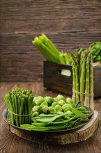 Various fresh green vegetables on wooden background