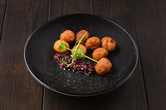 Plate with traditional scandinavian meatballs with cranberry sauce