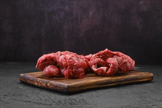 Raw peeled lamb boneless neck meat on cutting board