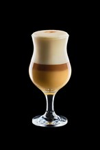 Big transparent glass with layered latte isolated on black background