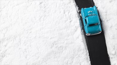 Close up view of blue toy car with snow