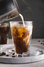 Milk pouring into glass with coffee. Resolution and high quality beautiful photo