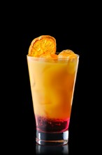 Cold refreching cocktail with orange juice and cherry syrup isolated on black background