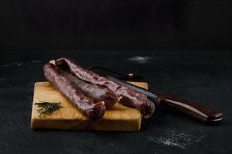 Dry cured beef sausage on cutting board