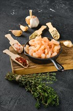 Frozen peeled shrimps in frying pan