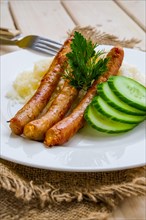 Fried sausage with mashed potato and fresh cucumber
